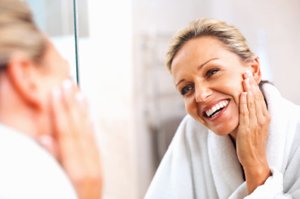 happy client looking at herself in mirror